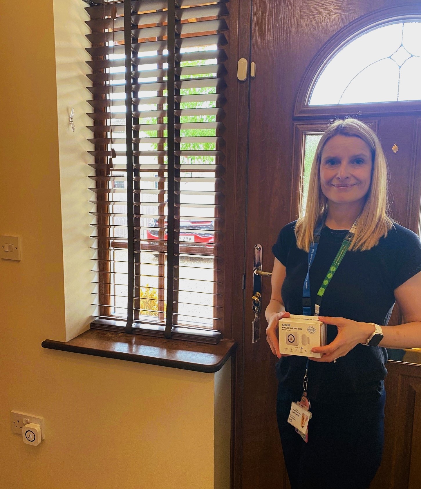 Occupation Therapist stood near front door with sensor alarm fitted at top